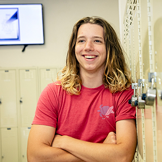 Chase James leaning against lockers