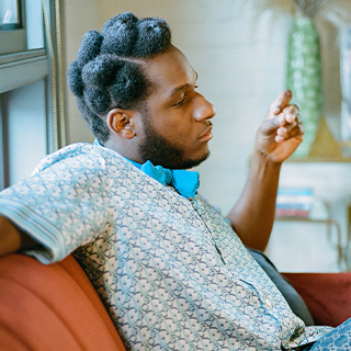 Leon sitting on couch in profile