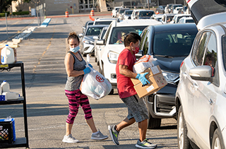 students loading food in cars