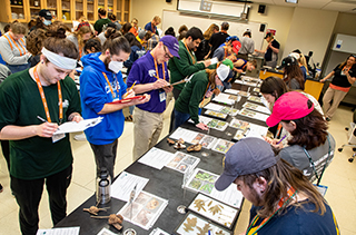 students filling out fomrs at horticulture event