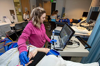 student using sonography wand