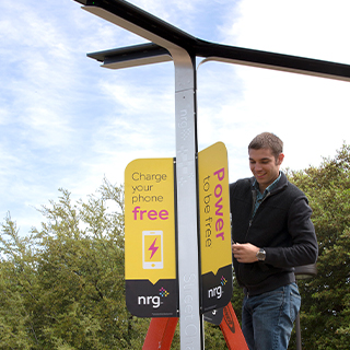 Employee installing a free charging station