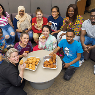 Group of international students eating snacks