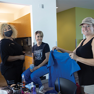 The makeup artist and costume designer prepare to work their magic before the commercial shoot begins.