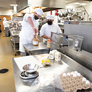 2 chefs working in the kitchen