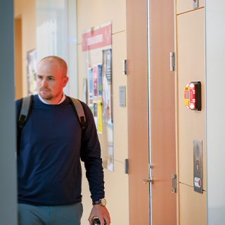 Man standing next to an emergency beacon