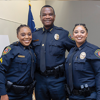 three smiling police officers
